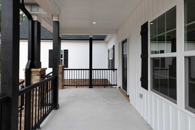 Covered porch with concrete floor and metal railing built by Wade Construction in Rock Hill, SC