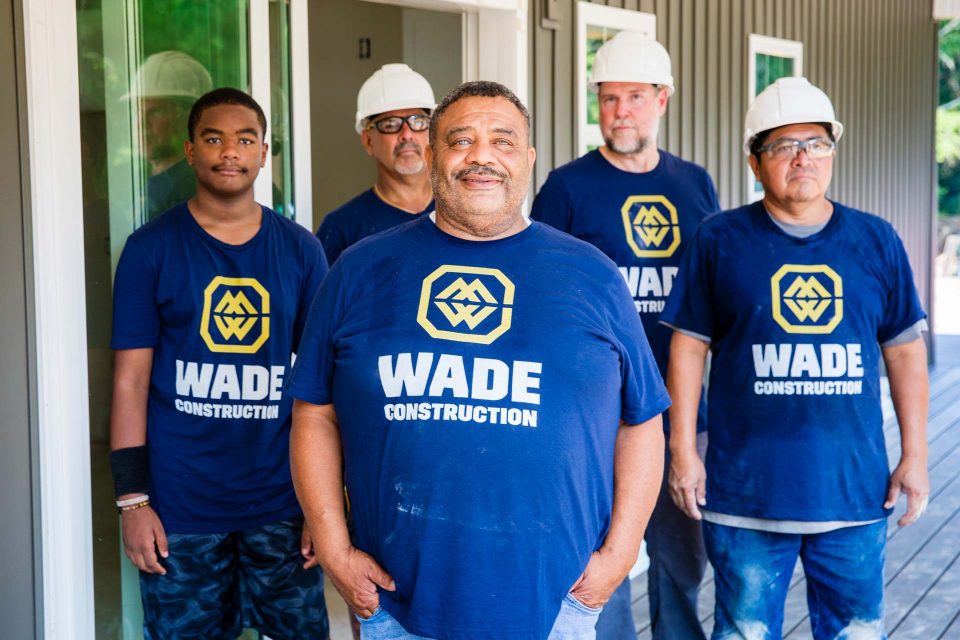 Wade Construction team members and home remodeling contractors pose for a group photo