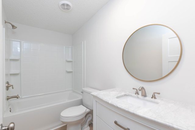 Bathroom remodel featuring white vanity and white shower tub combo by Wade Construction in Rock Hill, SC