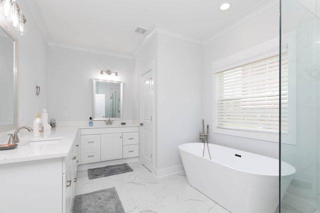 Newly remodeled bathroom featuring all white cabinetry and soaking tub designed and built by Wade Construction of Rock Hill, SC.